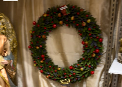 Decorative wreath with red berries on a neutral background