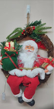 Hanging Christmas Wreath Garland with sitting  Santa Figure Santa LED lights 37w x48h cm Santas Workshop Direct